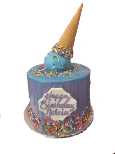 A cake decorated to look like an ice cream cone is melting on top of it.